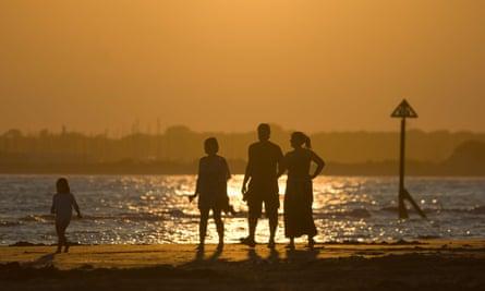 Family walking at West Wittering.