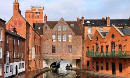 A river view of red-brick buildings in Birmingham.