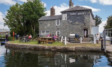 People relaxing outside the Turf Hotel