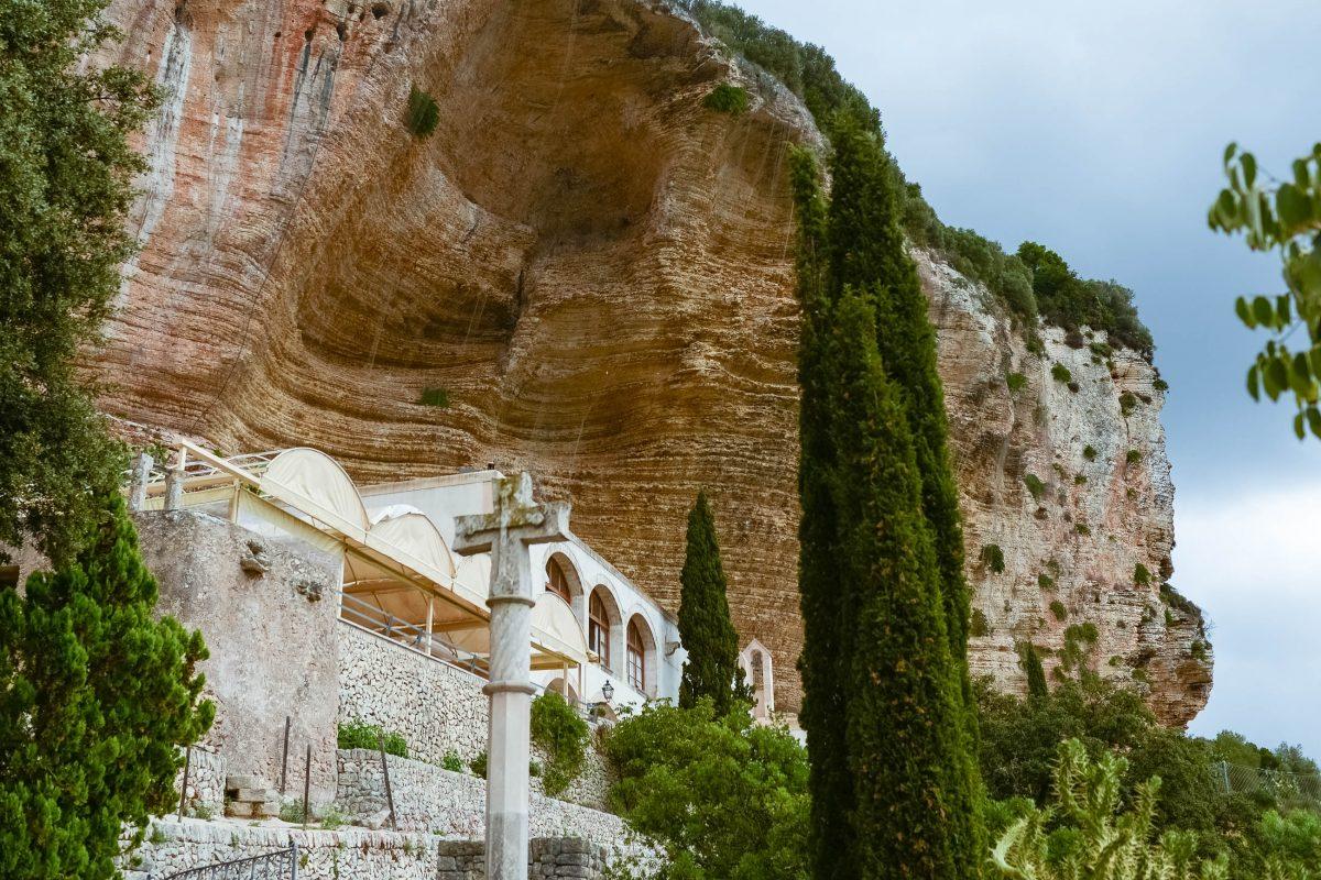 Only when you stand in front of it, the Santuari de Nostra Senyora de Gràcia at the monastery mountain Randa becomes visible under the steep slope, Mallorca, Spain - © James Camel / franks-travelbox