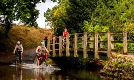 Damien Gabet, far left, tackles the ford at Castle Acre on the Rebellion Way in Norfolk
