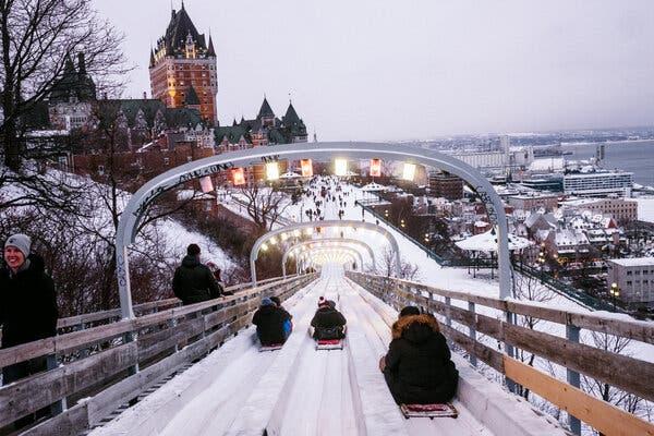 A toboggan slide runs along the promenade known as Dufferin Terrace toward the castlelike Fairmont le Château Frontenac in Québec City.