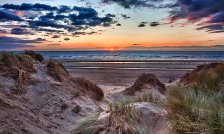 Sunset over Formby Beach through dunes.